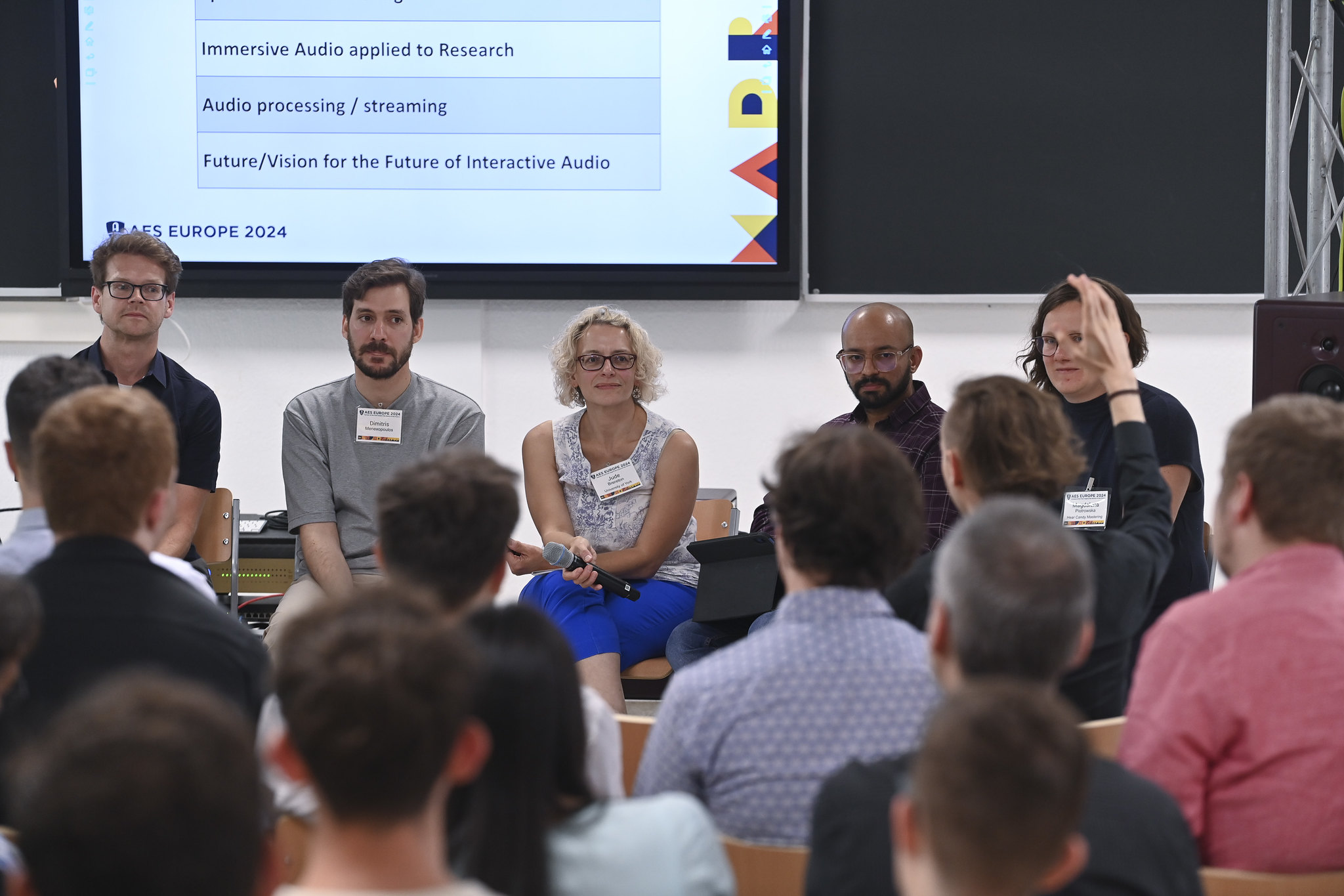 Attendees listen to panel of speakers at AES Europe 2024.